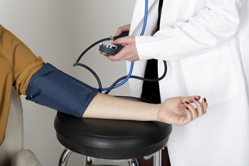 Doctor measures the blood pressure of a patient woman. Health