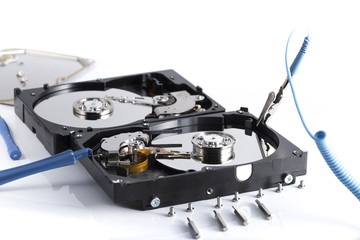 details of hard disk drive opened with evidence of the internal disk next to a cooling fan