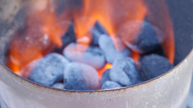 BBQ firestarter with coals in it and flames