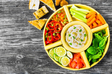 hummus, carrots, celery sticks, spinach, ginger, sliced lime, ol