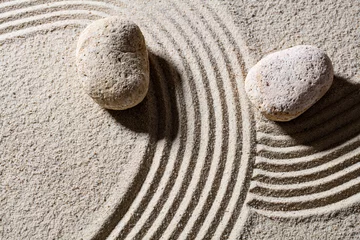 Fotobehang Zen Stenen zen sand still-life - two stones across lines to give different directions for concept of change or flexibility with peace, top view  © STUDIO GRAND WEB