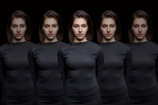 Group of young pretty women clones standing in a row