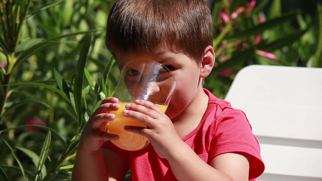 Boy drinking orange juice