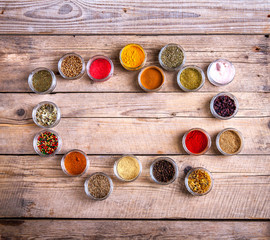 Spices in jars on wooden background. Food