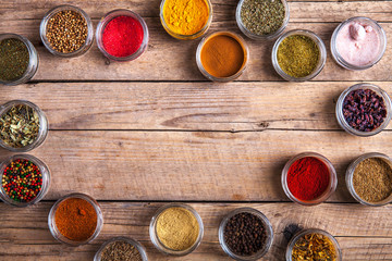 Spices in jars on wooden background. Food