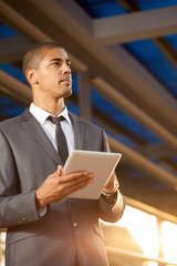  African American businessman using digital tablet