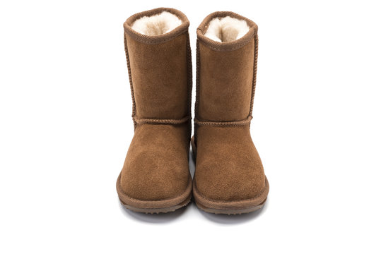 brown fluffy ugg boot style childrens footwear on white backgrou