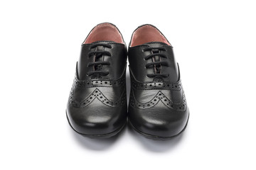 girls black school shoe on a white background