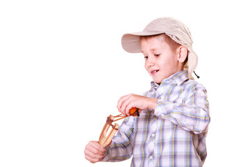 Young boy use sling shot shoot mandarine.