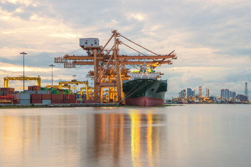 Fototapeta premium Industrial Container Cargo freight ship with working crane in sh
