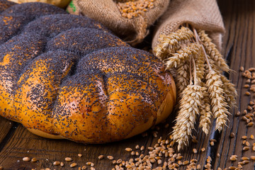 Assortment of baked bread on wooden table background