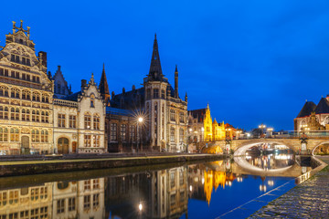 Fototapeta na wymiar Picturesque medieval building and St Michael's Bridge on the quay Graslei in Leie river at Ghent town at evening, Belgium