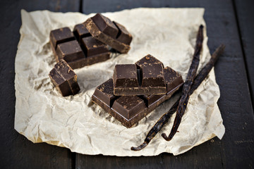 Chunks of dark chocolate bar and vanilla beans