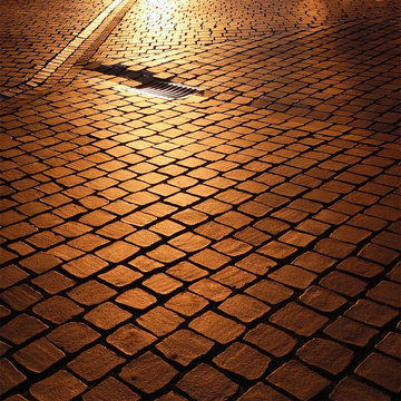 Fototapeta old town paving slabs at sunset