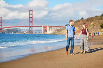 Romantic loving couple having a date on Baker beach in San Francisco