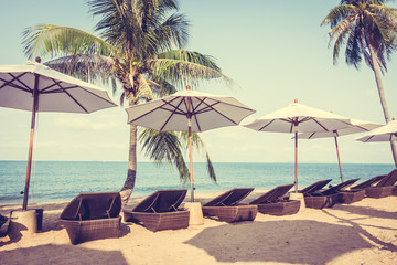 Umbrella and chair on the tropical beautiful beach