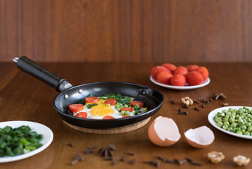 Fried eggs with tomatoes