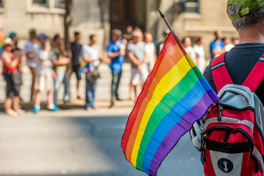 Man holds Rainbow gay flag