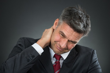 Businessman Suffering From Neck Pain