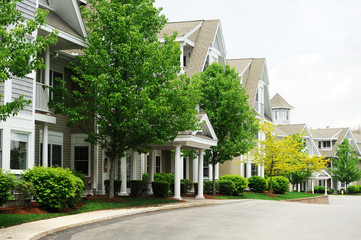 modern apartment buildings with spring green trees