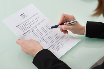 Person Hand Holding Resume