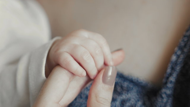Close up of Newborn Baby's and Mother Hand