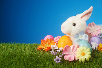Festive Easter background with rabbit, flowers, and colorful egg