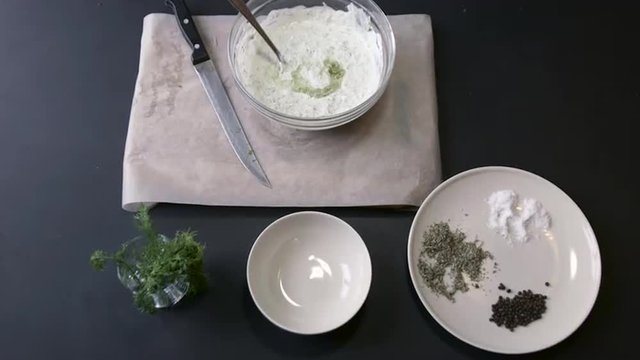 Chef Adding Olive Oil in a White Sauce and Mixes