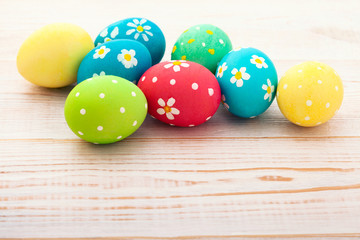 Fototapeta na wymiar Easter background. Colorful easter eggs with pattern flowers. Top view, horizontal. Poster, mock up for design. Selective focus