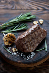 Close-up of grilled asado beefsteak on a rustic serving board