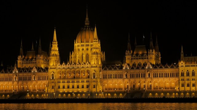 Hungarian national parliament building located on river Danube and city of Budapest by the night 4K 2160p UltraHD footage - Lighted night Budapest national parliament building 4K 3840X2160 UHD video 