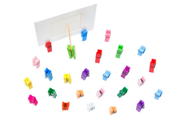 Green clothespin shows pointer on white frame another clothespin