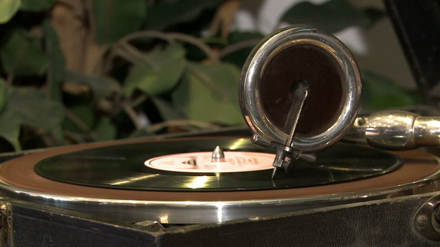 An antique gramophone.Vinyl record spinning on the player.