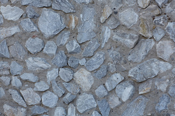 Gray stones in concrete. Texture.