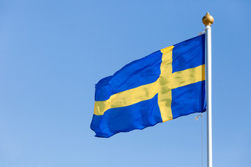 flag of Finland against the bright blue sky