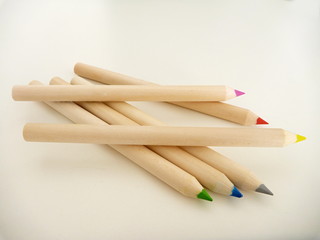 multi colored pencils on a white table