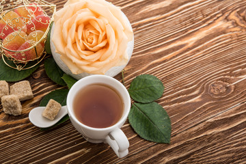 Tea cups with teapot on old wooden table