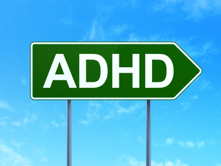 Medicine concept: ADHD on road sign background