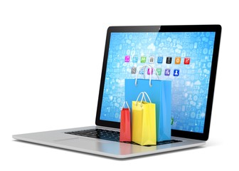 laptop and  shopping pags on white background