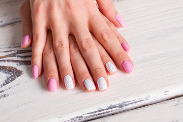 Obraz na płótnie Canvas White-pink manicure with ornaments.