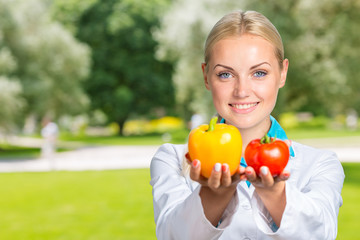 Portrait Of Happy Female Dietician With Fresh Vegetables