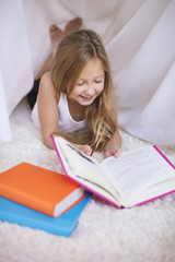 Elementary age girl reading a book