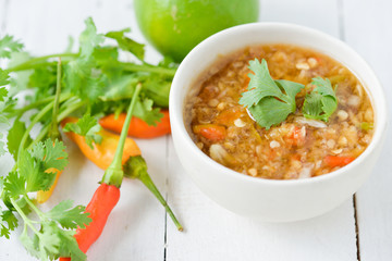 Spicy seafood dipping sauce for seafood on wood background