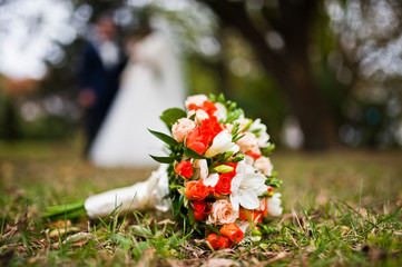 Wedding bouquet at grass background wedding couple