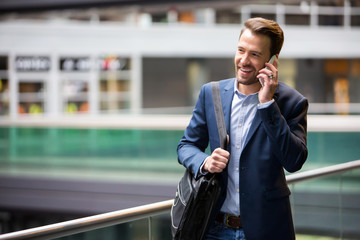 Young attractive business man using smartphone
