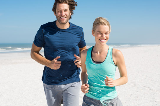 Couple Jogging On Beach