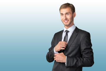 Confident young businessman buttoning cuff sleeves