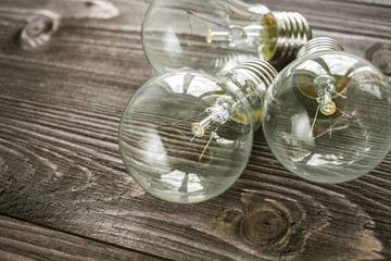 incandescent lamps on the wooden rustic background