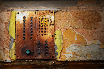 Dramatic grunge old wall with intercom panel buttons 