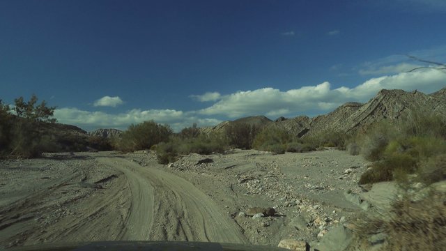 Offroad in Desierto De Tabernas with a Jeep Wrangler, Andalusia, Spain, filmed through the front window with reflections
